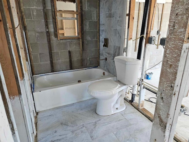 bathroom featuring a washtub and toilet