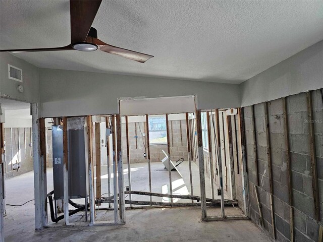 misc room with lofted ceiling and a textured ceiling