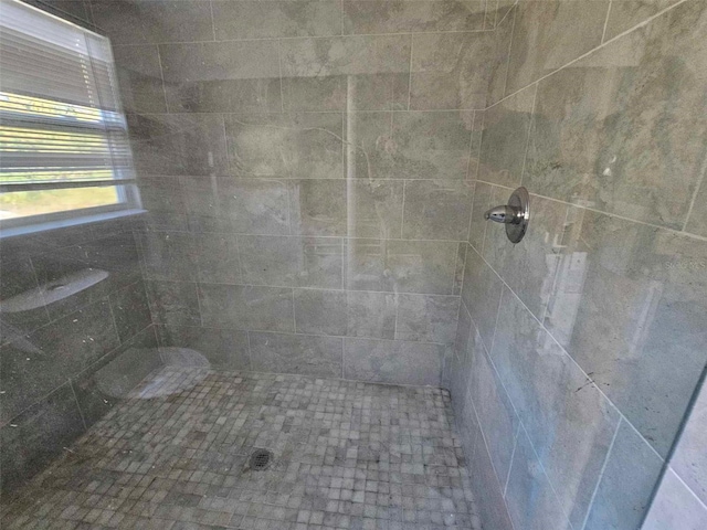 bathroom with a tile shower