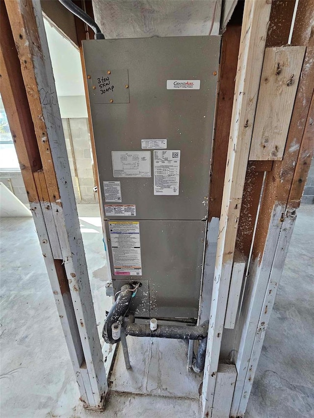 utility room featuring heating unit