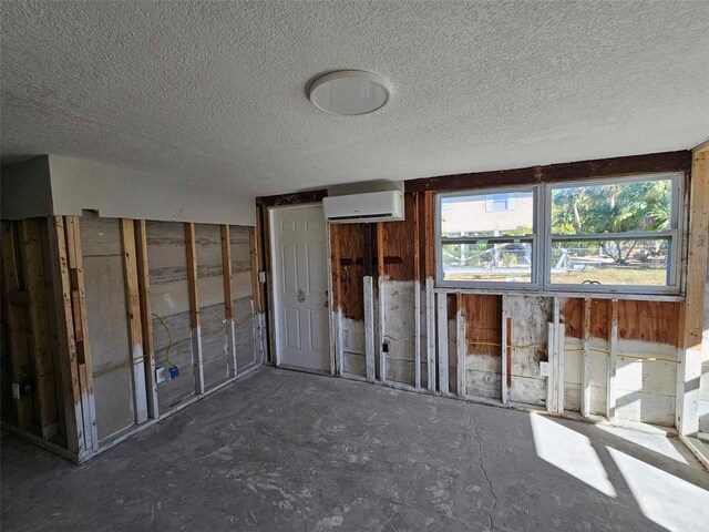 miscellaneous room featuring a textured ceiling and a wall mounted AC