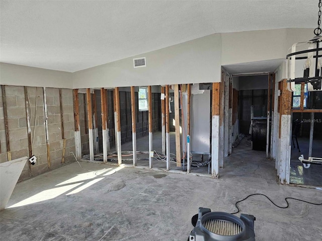 misc room featuring a textured ceiling and vaulted ceiling