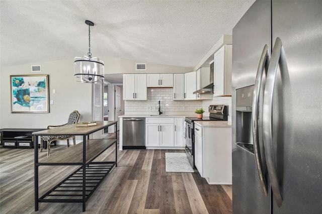 kitchen with lofted ceiling, sink, white cabinetry, and stainless steel appliances