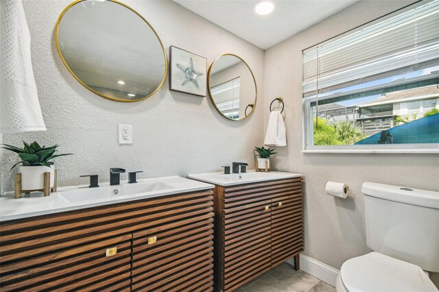 bathroom with tile patterned floors, vanity, and toilet