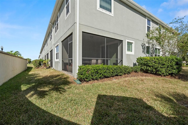 rear view of house featuring a yard