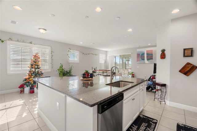 kitchen featuring dishwasher, white cabinets, a center island with sink, and sink