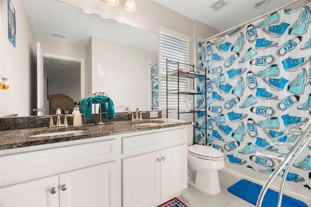 full bathroom featuring tile patterned floors, vanity, shower / bath combination with curtain, and toilet