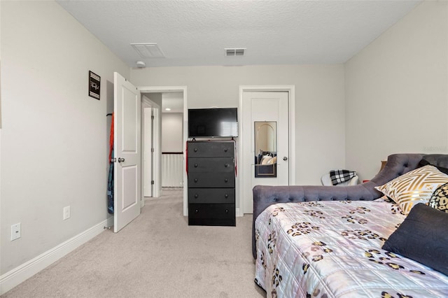 carpeted bedroom with a textured ceiling