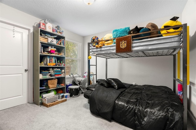 bedroom with a textured ceiling and carpet floors