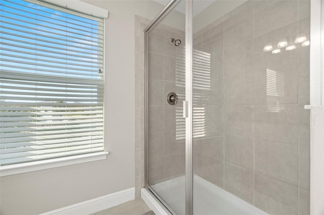 bathroom featuring a shower with door