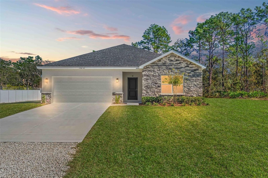 view of front of home featuring a yard and a garage