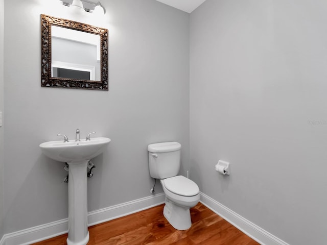 bathroom featuring toilet and hardwood / wood-style flooring