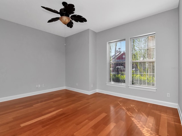 spare room with ceiling fan and wood-type flooring