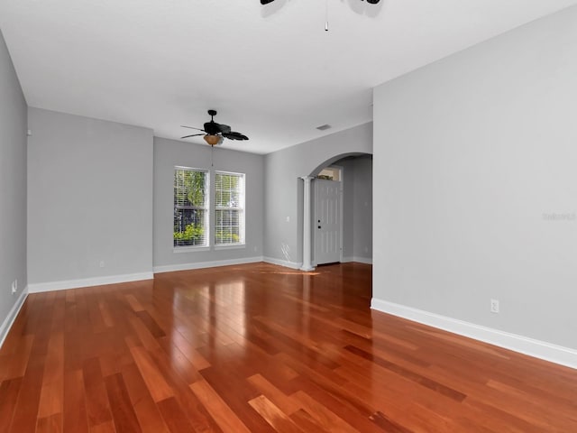 spare room with hardwood / wood-style floors and ceiling fan