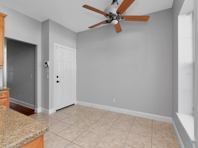 interior space with ceiling fan and light tile patterned floors