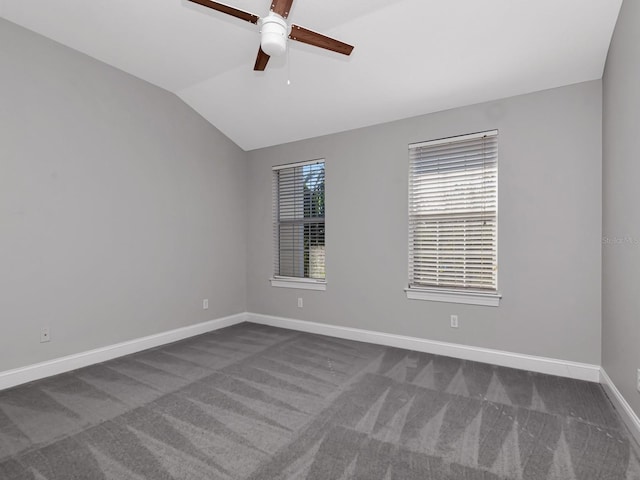 carpeted empty room with ceiling fan and vaulted ceiling