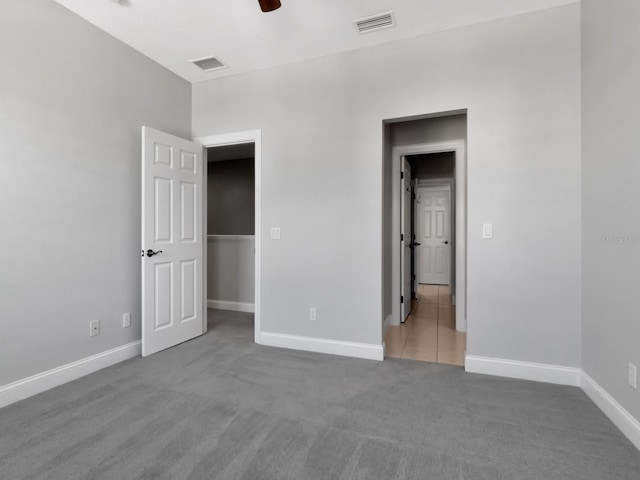 unfurnished bedroom with ceiling fan and carpet floors