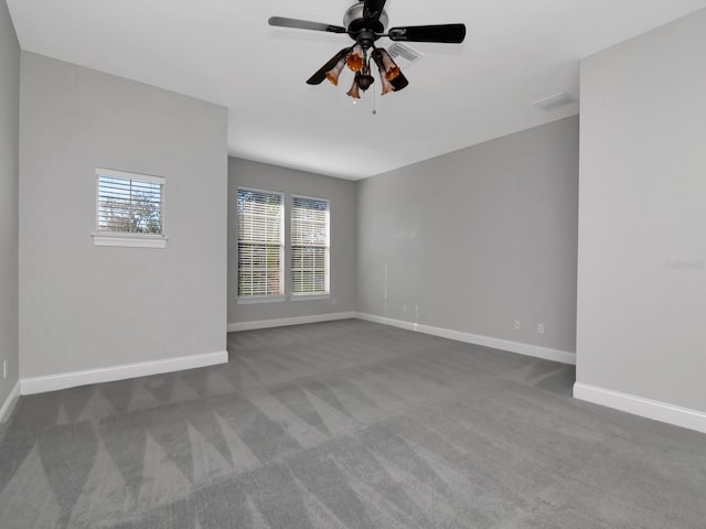 carpeted spare room with ceiling fan