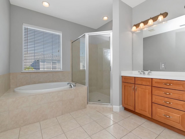 bathroom featuring tile patterned flooring, vanity, and shower with separate bathtub