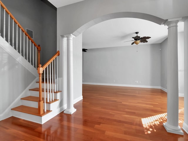 staircase with ceiling fan and hardwood / wood-style floors