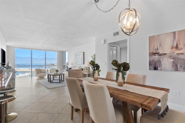 tiled dining space featuring an inviting chandelier and floor to ceiling windows