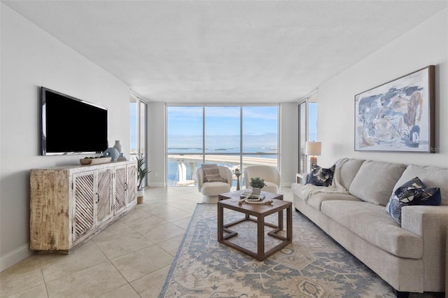 tiled living room with floor to ceiling windows