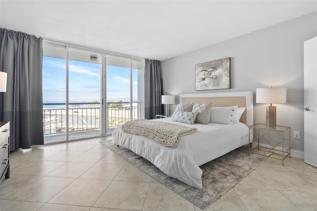 tiled bedroom with a water view, a wall of windows, and access to outside