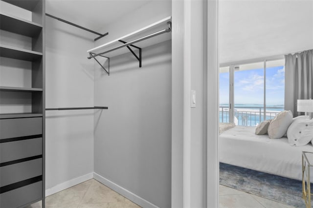 walk in closet featuring light tile patterned flooring