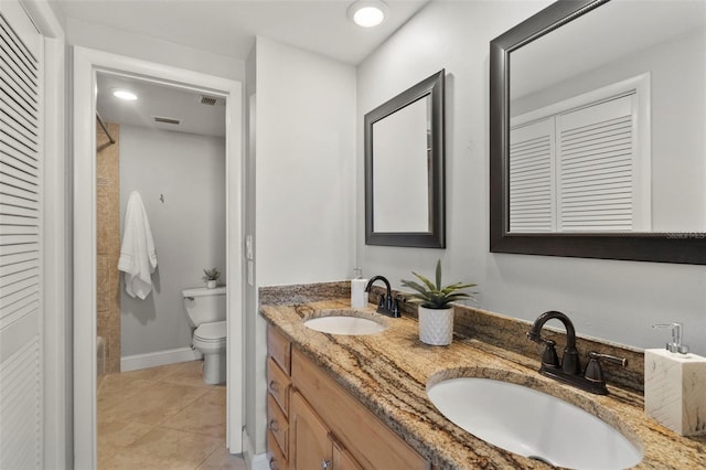 bathroom with tile patterned floors, vanity, and toilet