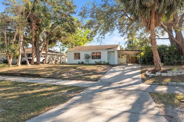 view of front facade featuring a front lawn and a carport