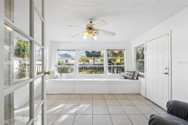 sunroom / solarium featuring plenty of natural light and ceiling fan