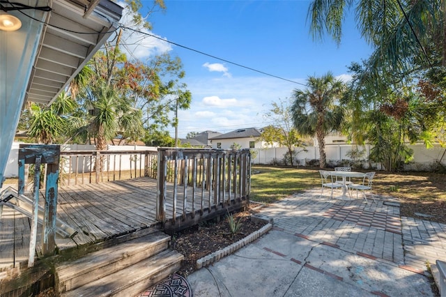 deck with a yard and a patio