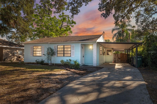 view of front facade with a gate, driveway, and an attached carport
