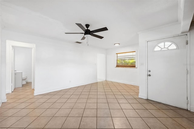 foyer entrance featuring light tile patterned flooring, visible vents, a ceiling fan, and baseboards