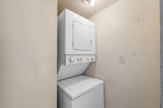 laundry room with stacked washer and clothes dryer and laundry area