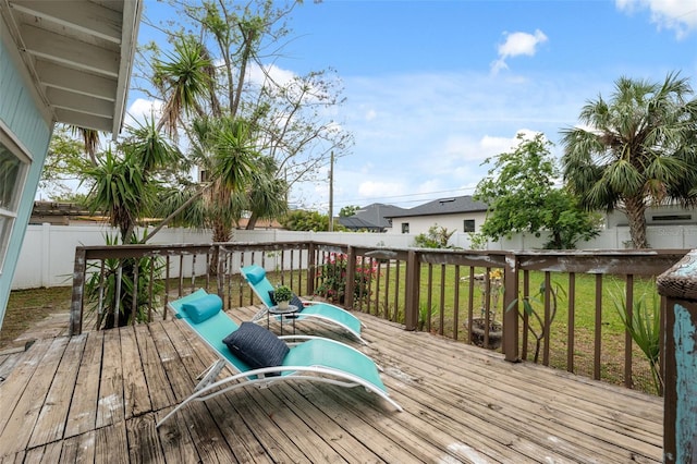 wooden terrace with a fenced backyard and a yard