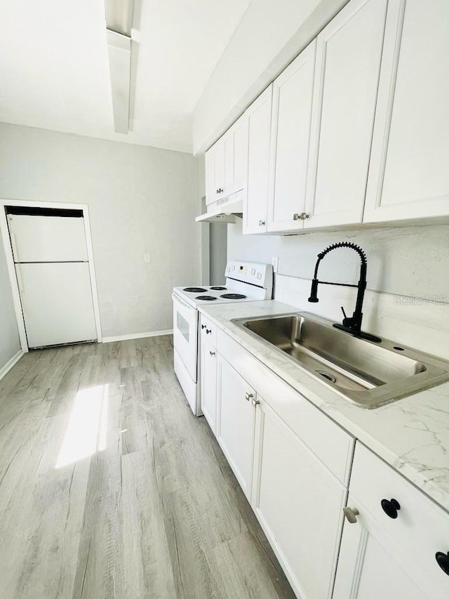 kitchen with electric range, sink, light stone counters, light hardwood / wood-style floors, and white cabinets