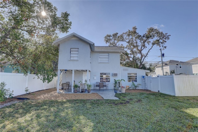 rear view of house with a patio area and a yard