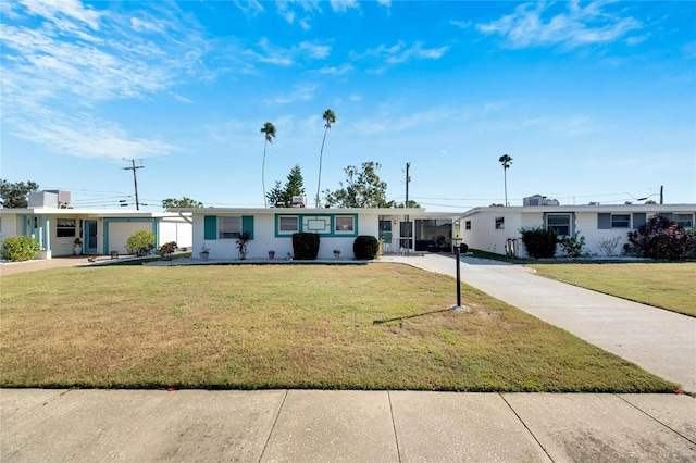 single story home featuring a front yard and a carport