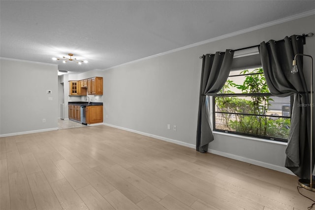 unfurnished living room featuring sink, ornamental molding, a notable chandelier, and light wood-type flooring