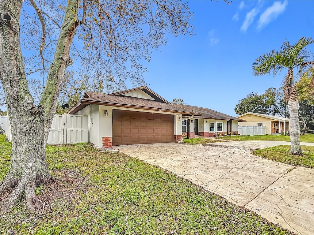 ranch-style house with a garage and a front yard