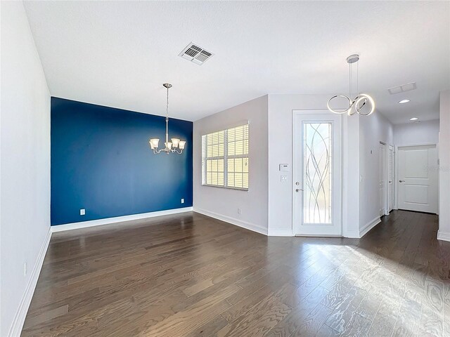 interior space featuring dark hardwood / wood-style floors and a notable chandelier