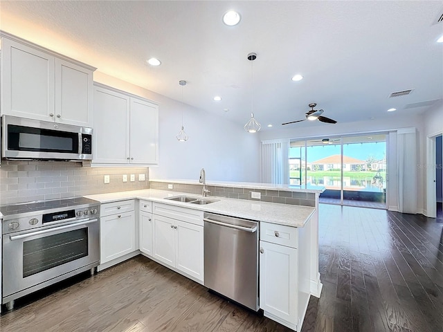 kitchen featuring white cabinetry, sink, kitchen peninsula, and stainless steel appliances