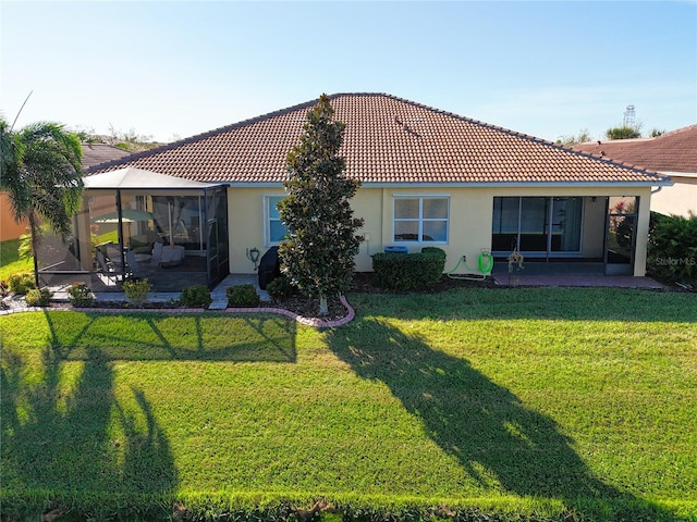 rear view of property with a lawn and a patio area