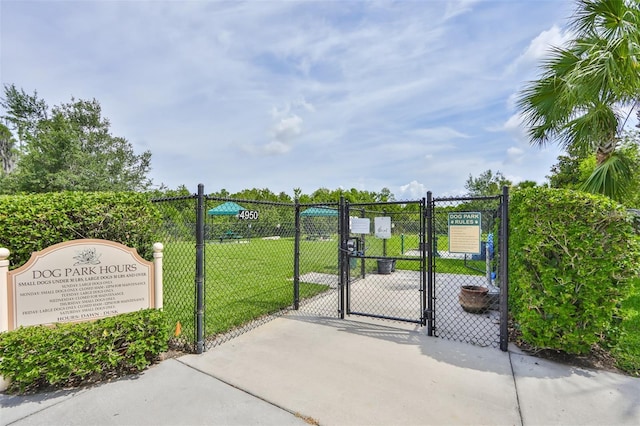 view of gate with a yard