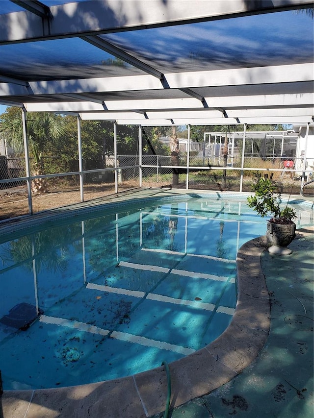 view of swimming pool with a lanai