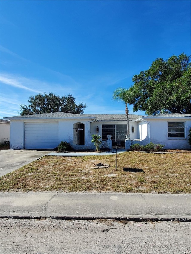 ranch-style house with a garage and a front yard