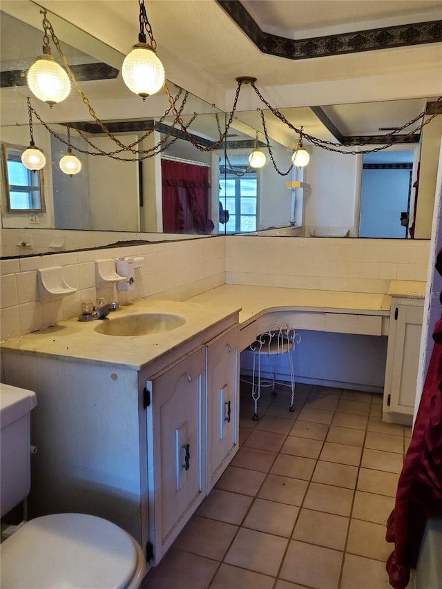 bathroom featuring tile patterned floors, vanity, toilet, and tasteful backsplash