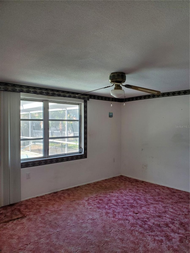 unfurnished room featuring carpet, ceiling fan, and a textured ceiling