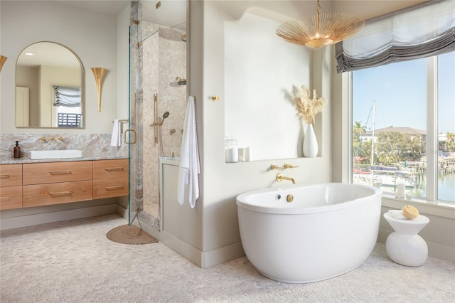 bathroom featuring separate shower and tub, a water view, and vanity